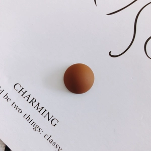 Detailed macro shot of 14mm matte brown resin semi-circle charm for DIY crafts