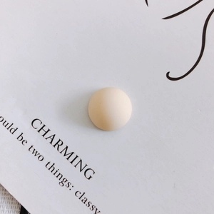 Close-up of a matte beige resin geometric dome cabochon for DIY phone cases and shoes