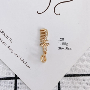 Detailed view of gold-plated comb pendant with rhinestones and 36x10mm size specs
