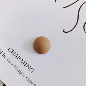 Close-up of matte brown resin geometric bead for DIY phone cases and craft accessories