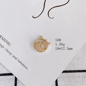 Detail of 18K gold plated moon and star pendant with sparkling pavé zircons