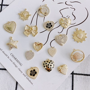 DIY jewelry charms set with gold alloy, pearls, and rhinestones on aesthetic cards