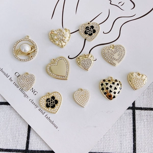 DIY jewelry charms featuring heart shapes, pearls, and crystals in gold-plated alloy