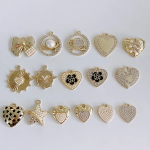 Detailed set of 16 gold alloy pendants featuring pearls, rhinestones and heart designs
