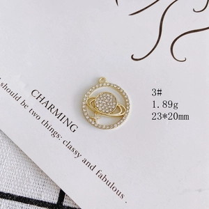 Detailed view of golden Saturn pendant with pearls and rhinestones, size 23x20mm