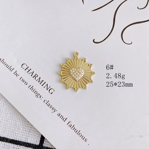 Detailed view of a golden sunburst pendant with heart pearls, 25x23mm jewelry finding