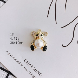 Golden bear pendant with pearl belly, rhinestone ears, and LOVE engraving, 26x19mm detail