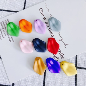 Flat lay of colorful matte resin flower petal charms for DIY jewelry making