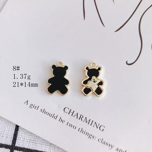 Close-up of black bear alloy charms with gold edges and dimensions for DIY jewelry