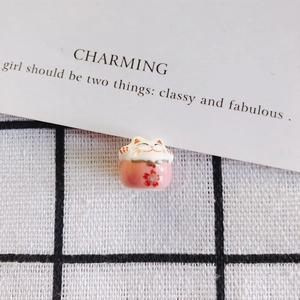Detailed view of mini pink ceramic lucky cat bead with hand-painted cherry blossoms