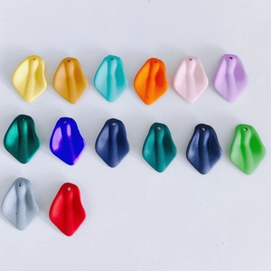 Flat lay of colorful DIY resin flower petal charms with matte and metallic finishes