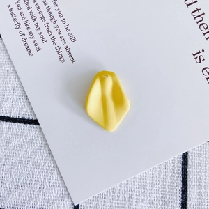 Detailed close-up of yellow petal-shaped resin pendant for DIY jewelry making
