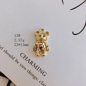 Close-up of golden bear astronaut pendant with 23x13mm size and 2.57g weight specs