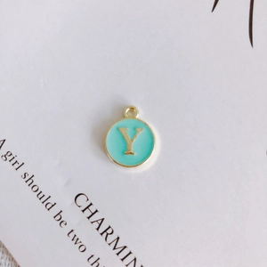 Detail view of round gold enamel letter Y pendant for DIY jewelry making material