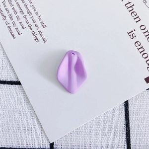 Detail of purple resin flower petal pendant with matte finish and pre-drilled hole for DIY