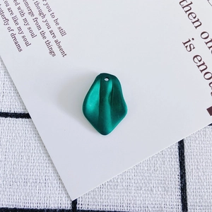 Detail of dark green resin flower petal pendant with matte texture for DIY jewelry making