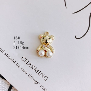 Detailed macro view of a 21x14mm gold bear pendant with pearls and rhinestones