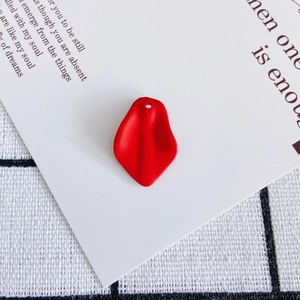 Detailed view of a matte red resin petal pendant with a top hole for DIY jewelry making