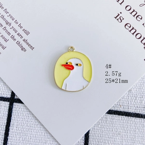 Detail view of 4# white duck enamel pendant with gold border and yellow background charm