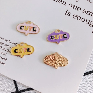 Cute speech bubble alloy pendants with colorful CUTE text on stylized paper background
