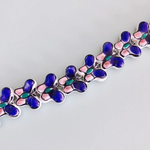 Macro view of colorful butterfly ceramic beads for DIY jewelry with painted details