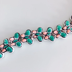 Macro shot of colorful glazed ceramic butterfly beads for DIY jewelry and bracelets