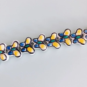 Detailed macro view of colorful butterfly ceramic beads for DIY jewelry and crafts