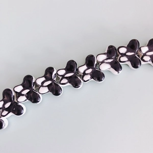 Close-up of DIY butterfly ceramic beads with polished black and white glaze finish