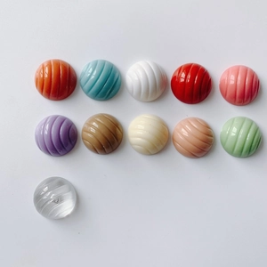 Macro shot of 11 assorted colors of resin beads with spiral texture for DIY crafts