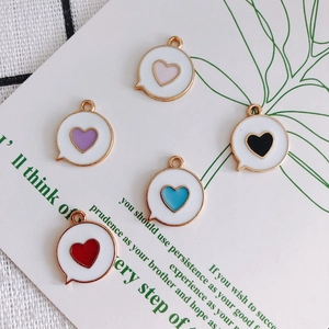 Five heart-shaped bubble pendants in red blue black purple and pink with gold edges