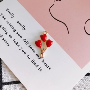 Detailed view of red enamel heart balloon charm for DIY jewelry making and crafts