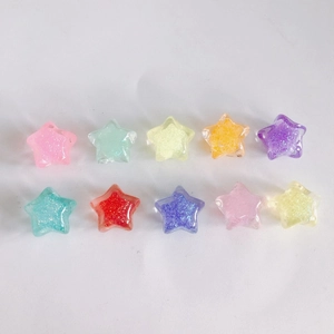 Close-up of 10 colorful glitter star-shaped resin charms for DIY jewelry making