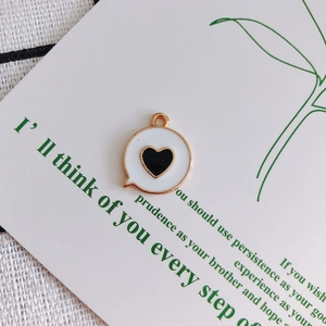Detail view of heart enamel pendant on white display card for DIY jewelry making