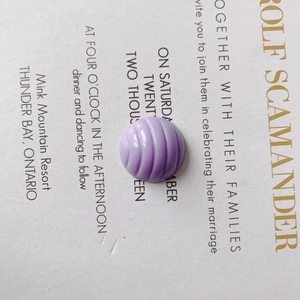 Macro shot of purple spiral textured resin bead for DIY shoe charms and crafts