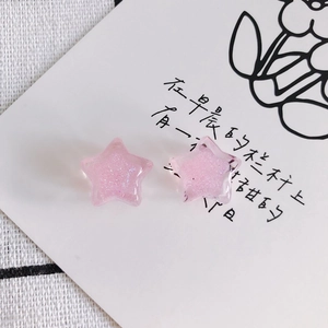 Close-up of a pink star resin charm with fine glitter for DIY jewelry making