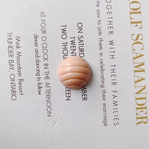 Close-up of pink round resin bead with stripe texture for DIY shoe accessories