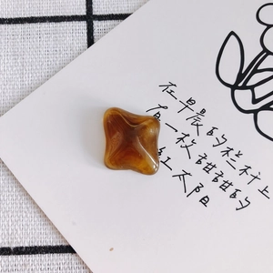 Gros plan de patchs carrés en résine ambrée avec relief en croix pour bijoux DIY
