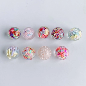 Macro de 9 sphères en résine transparente avec des paillettes colorées et des perles