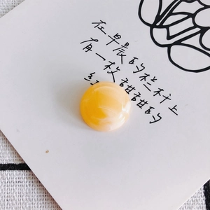 Macro detail of a yellow gradient resin cabochon bead for DIY jewelry and crafts