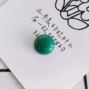 Macro detail of a polished green malachite cabochon bead for DIY jewelry making