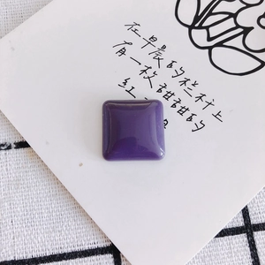 Close-up of a square purple resin cabochon with glossy finish for DIY accessories