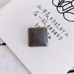 Macro detail of a square resin stone charm with polished finish for DIY jewelry crafts