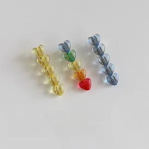 Detail of colorful transparent resin heart hair clips with a glossy candy texture