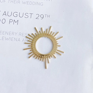 Detail of 14k gold plated sunburst pendant with radiant lines for DIY jewelry making