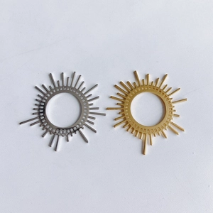 Macro detail of sunburst jewelry charms in gold and silver plating for DIY accessories