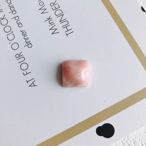 Close-up of pink marble resin charm for DIY jewelry and phone case accessory