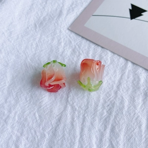 Détail macro de pendentifs rose en résine avec pétales dégradés roses et sépales verts