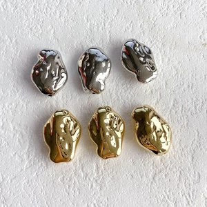 Detailed view of irregular molten-style gold and silver plated resin beads for jewelry DIY