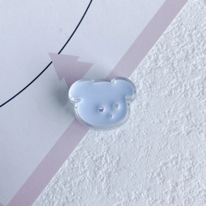 Close-up of a cute light blue resin bear charm for DIY accessories and crafts