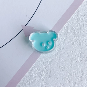 Close-up of mint green bear-shaped acrylic DIY accessory with transparent resin finish